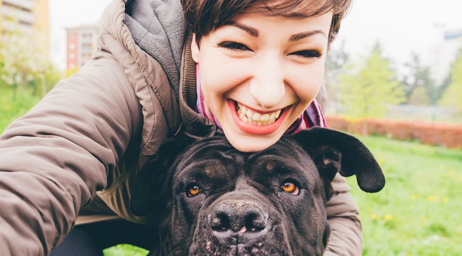 girl taking selfie with mastif dog